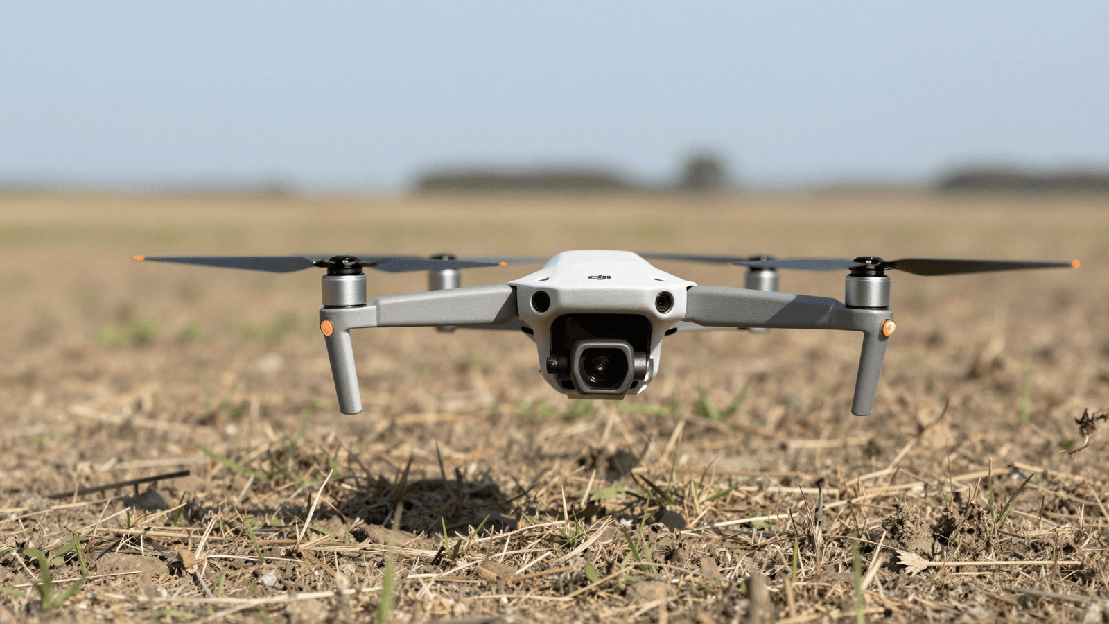 Piloto preparando um drone DJI para decolar em campo aberto