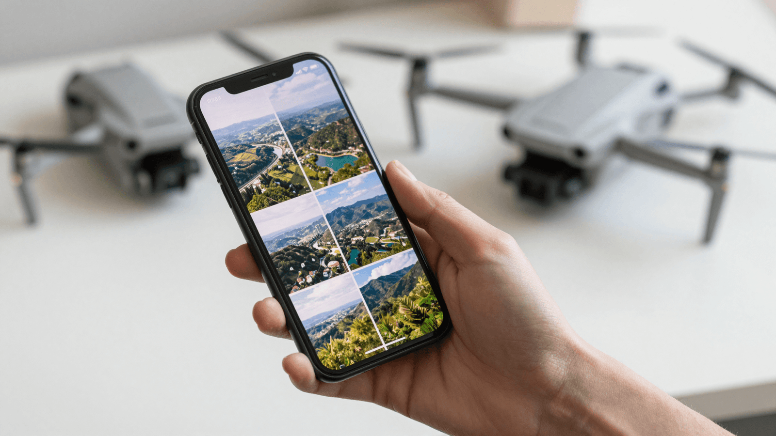 Smartphone exibindo um portfólio em grade de fotos aéreas feitas com drone