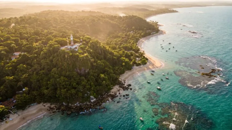 Vista aerea das praias turquesa e do farol de Morro de Sao Paulo ao entardecer